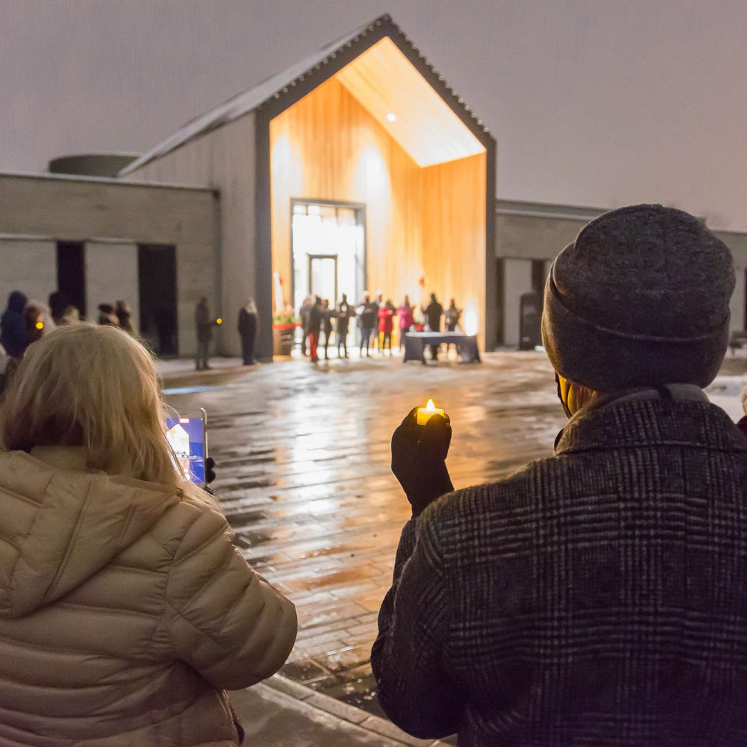 People holding candles at the Lights of Love event