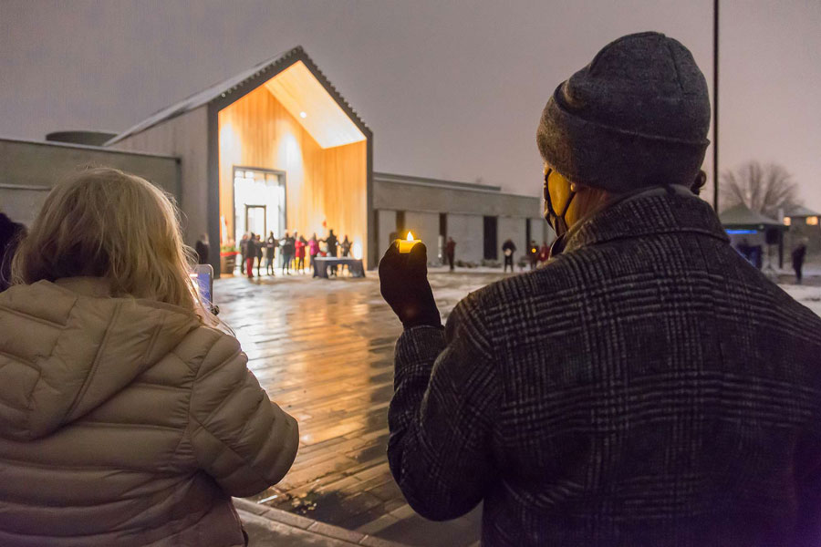 Man holding a candle at a vigil Man holding a candle at a vigil