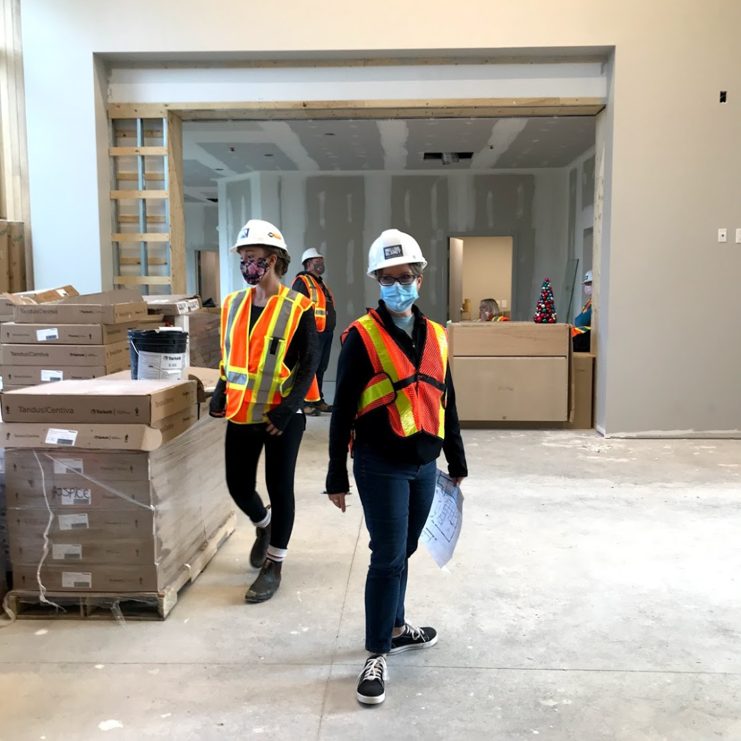 13 HWR staff dressed in orange vests and wearing masks help with move in at The Gies Family Centre