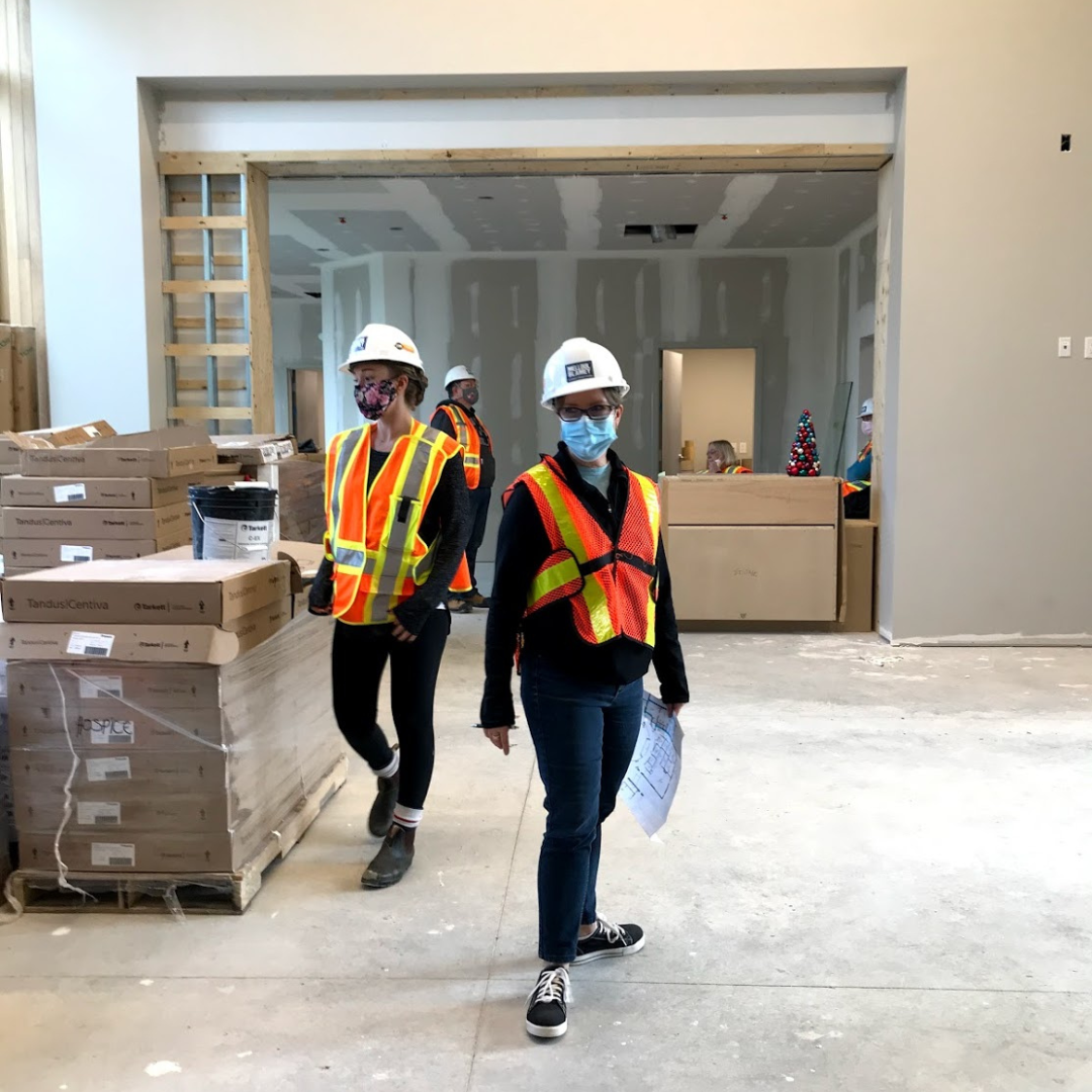 HWR staff dressed in orange vests and wearing masks help with move in at The Gies Family Centre