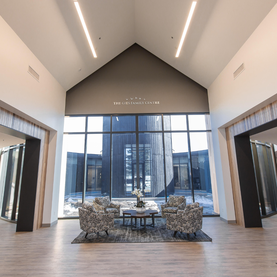 17 Front entrance of The Gies Family Centre, featuring four chairs and a table