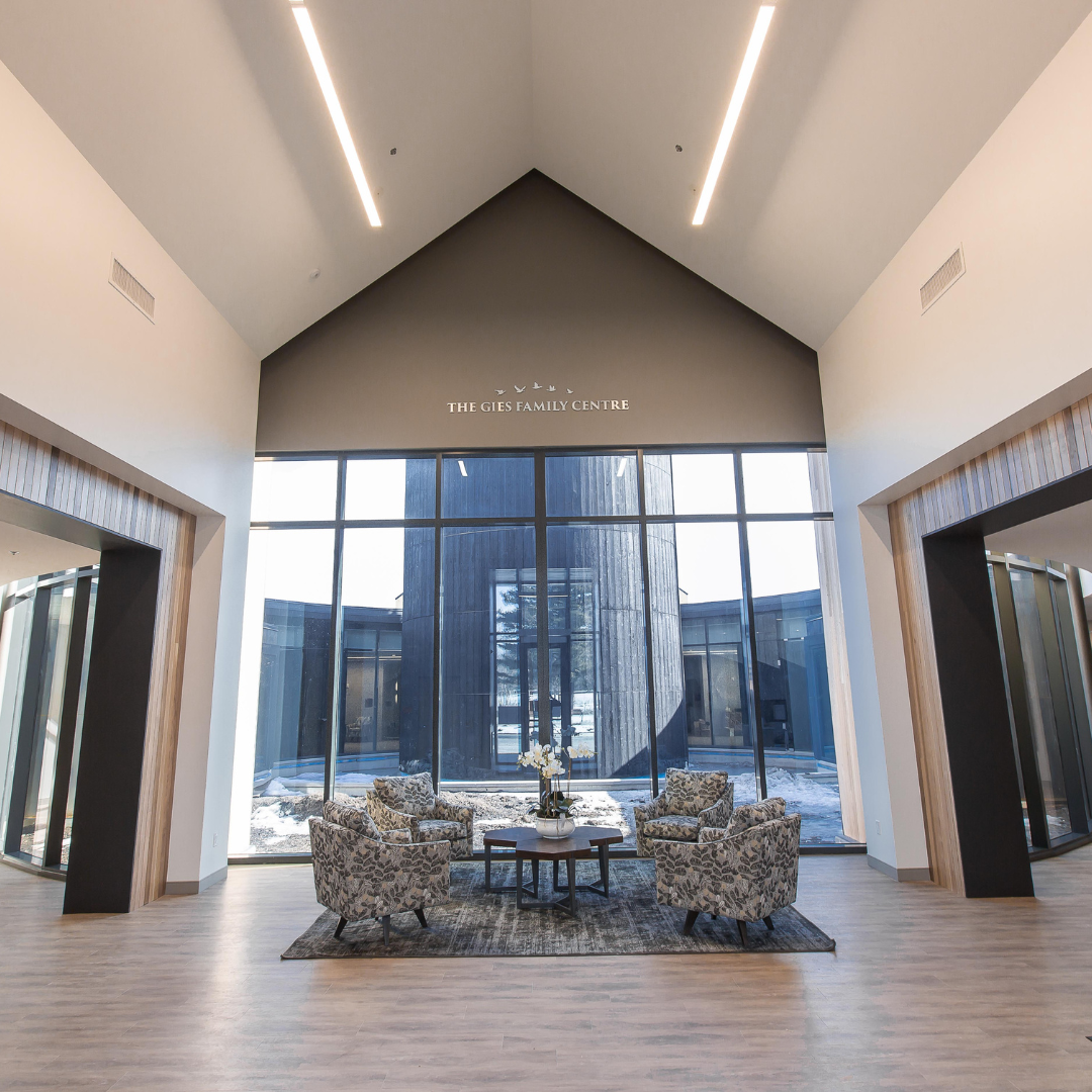 Front entrance of The Gies Family Centre, featuring four chairs and a table