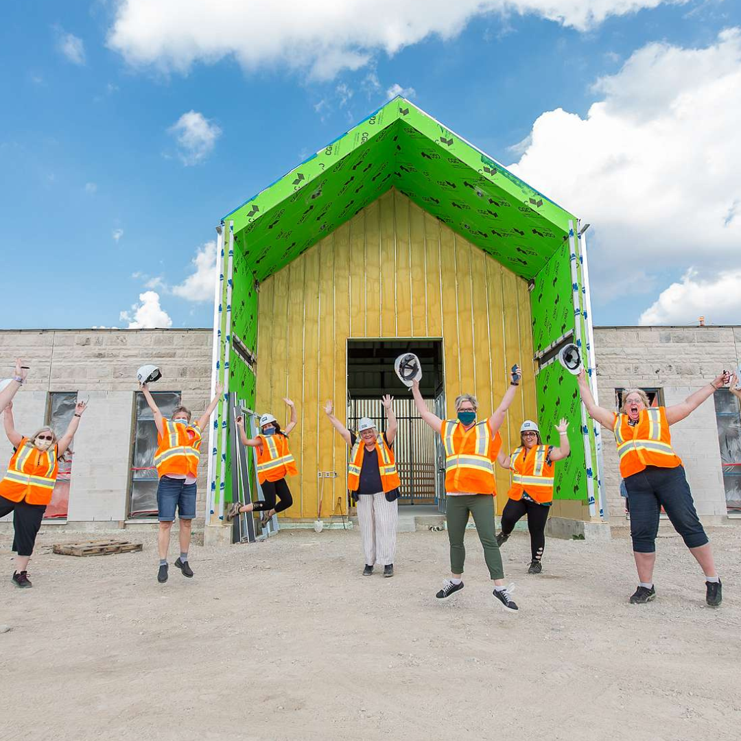 4 Staff jumping in front of the building