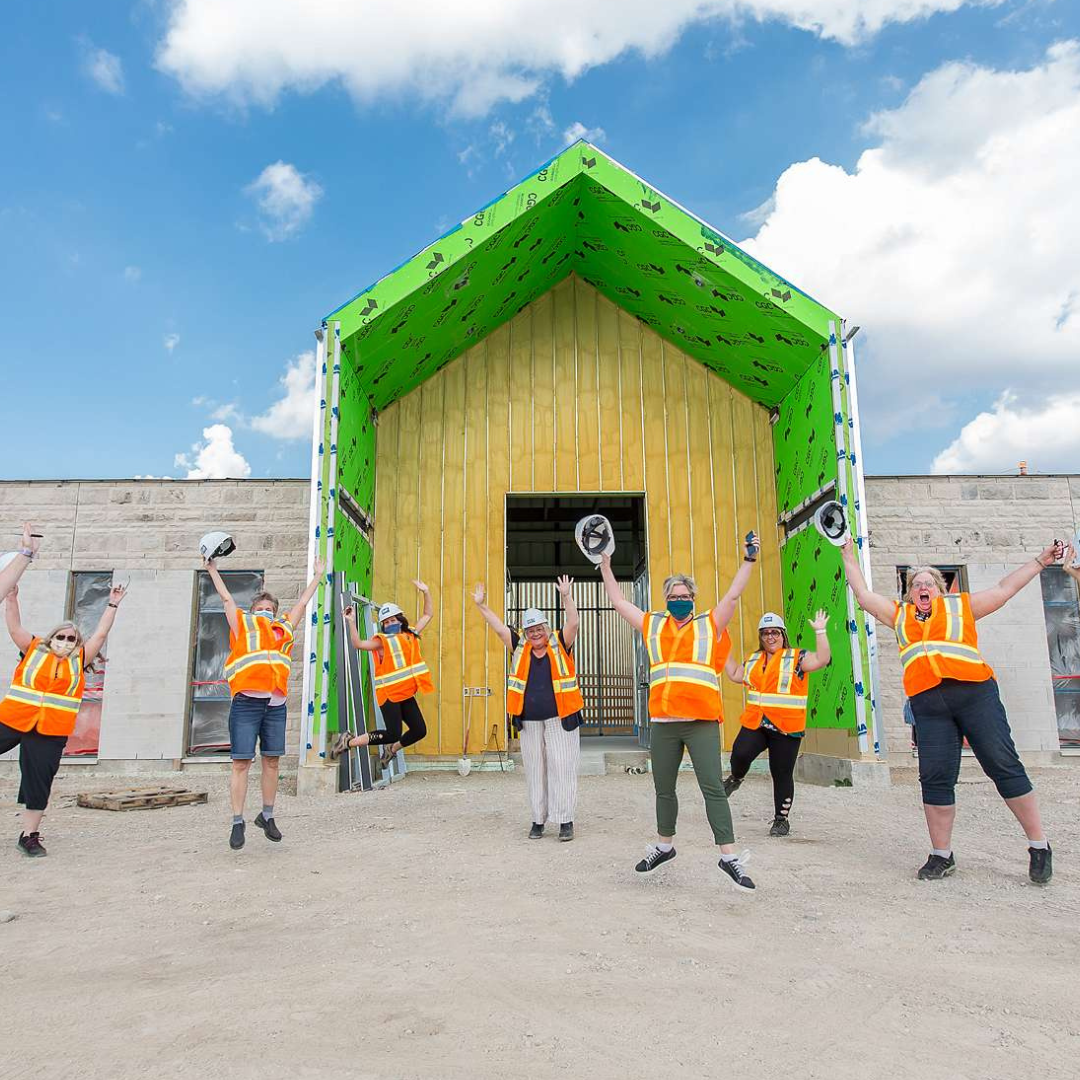 Staff jumping in front of the building