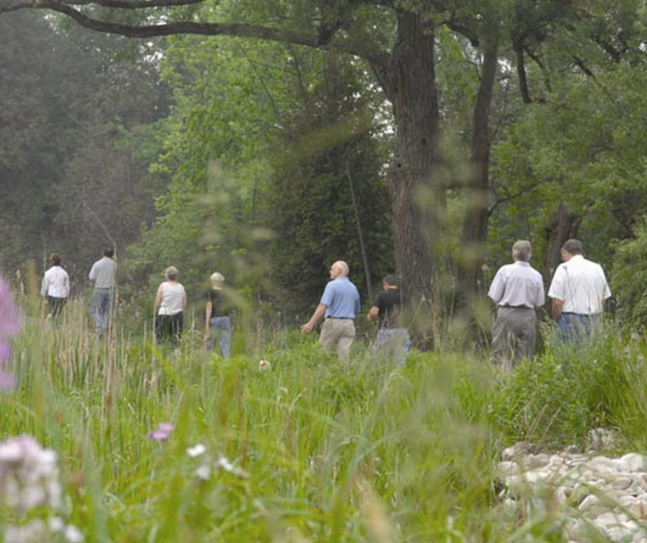 A group of people walking in a field