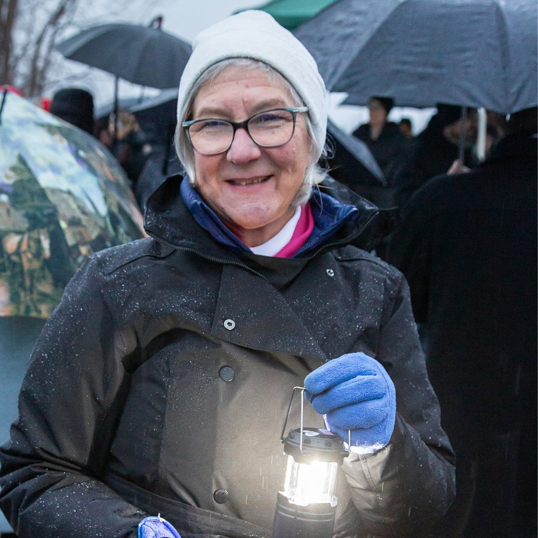 Woman holding a lantern.